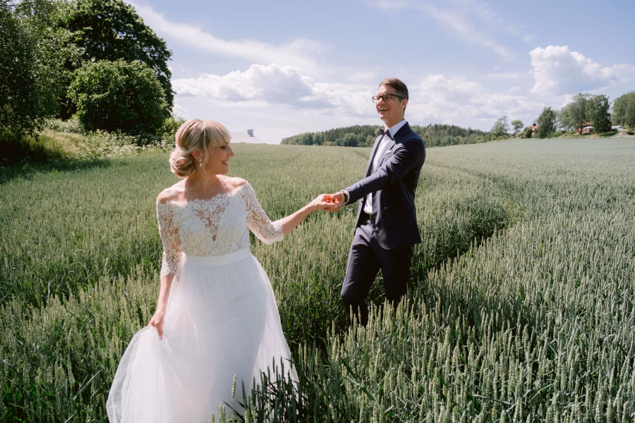 Couple walking hand in hand in soft summer light